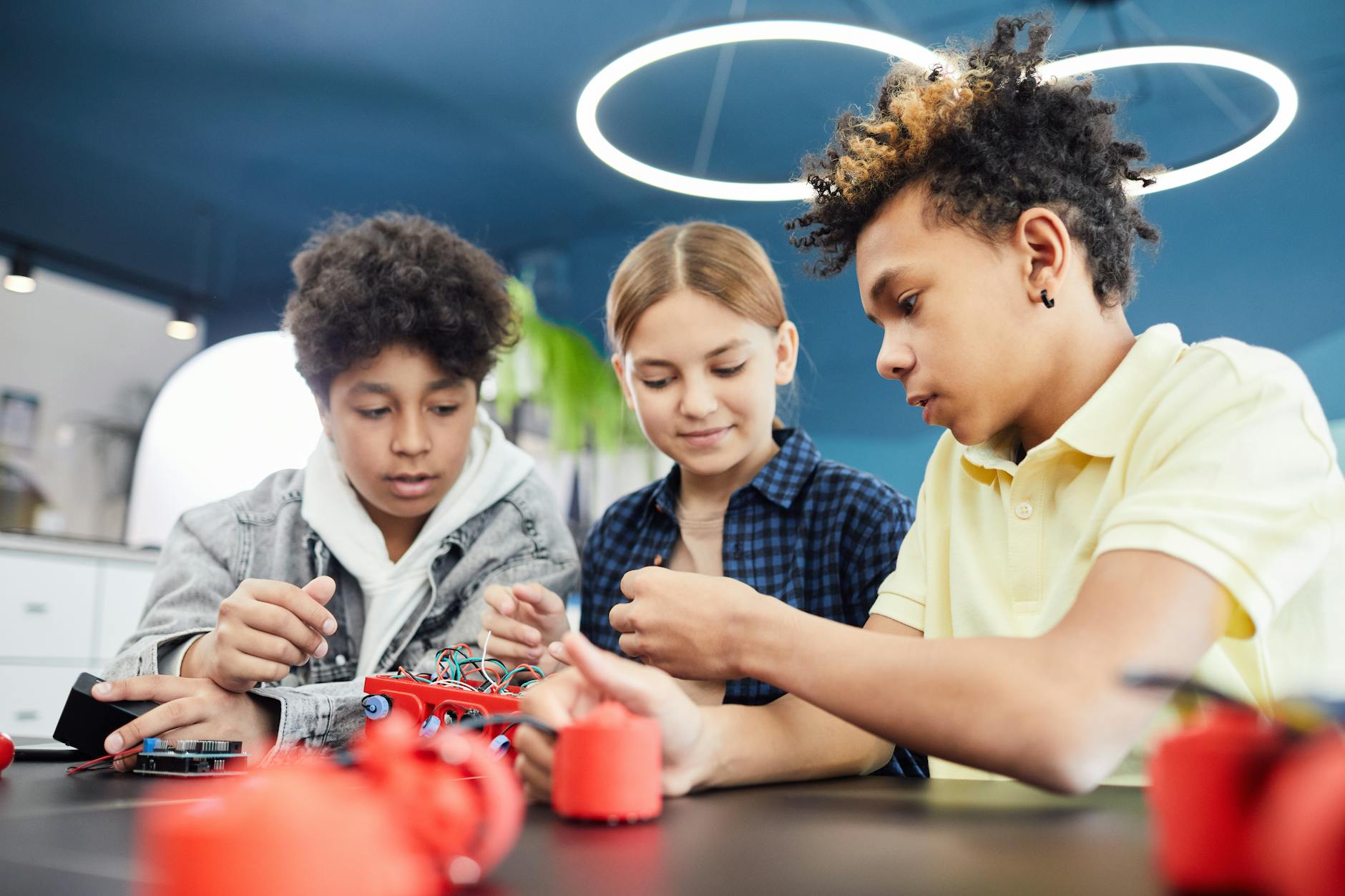 young students doing robotics together